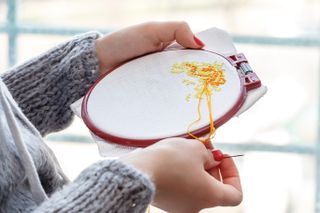 Woman cross stitching