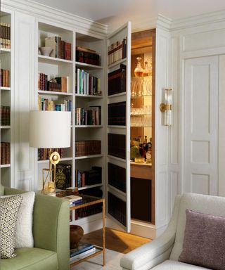 Studio QD Trompe-l'œil bookshelf cupboard door opening to mini bar