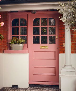 pink front door of a traditional victorian home