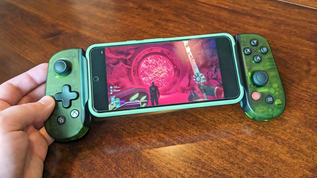 A hand holding the Backbone One Xbox Edition while it plays Avowed.