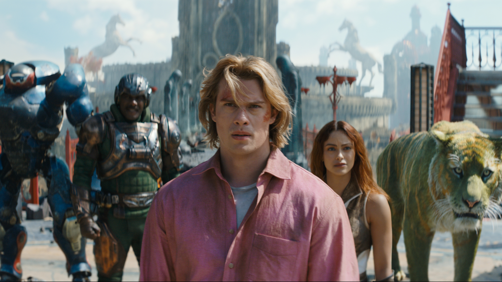  Roboto (Kristen Wiig), Man At Arms (Idris Elba), Adam (Nicholas Galitzine), Teela (Camila Mendes) and Cringer in MASTERS OF THE UNIVERSE.