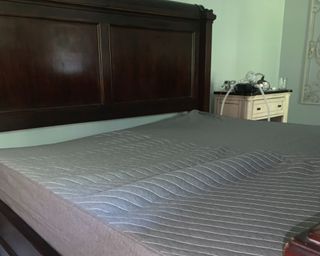 Best mattress siena being reviewed on dark wood bed frame