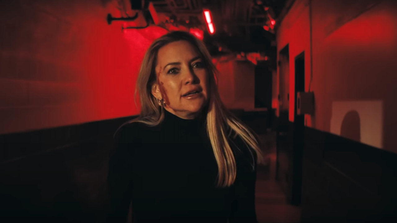 Kate Hudson with blood on her face in red lit room in Shell