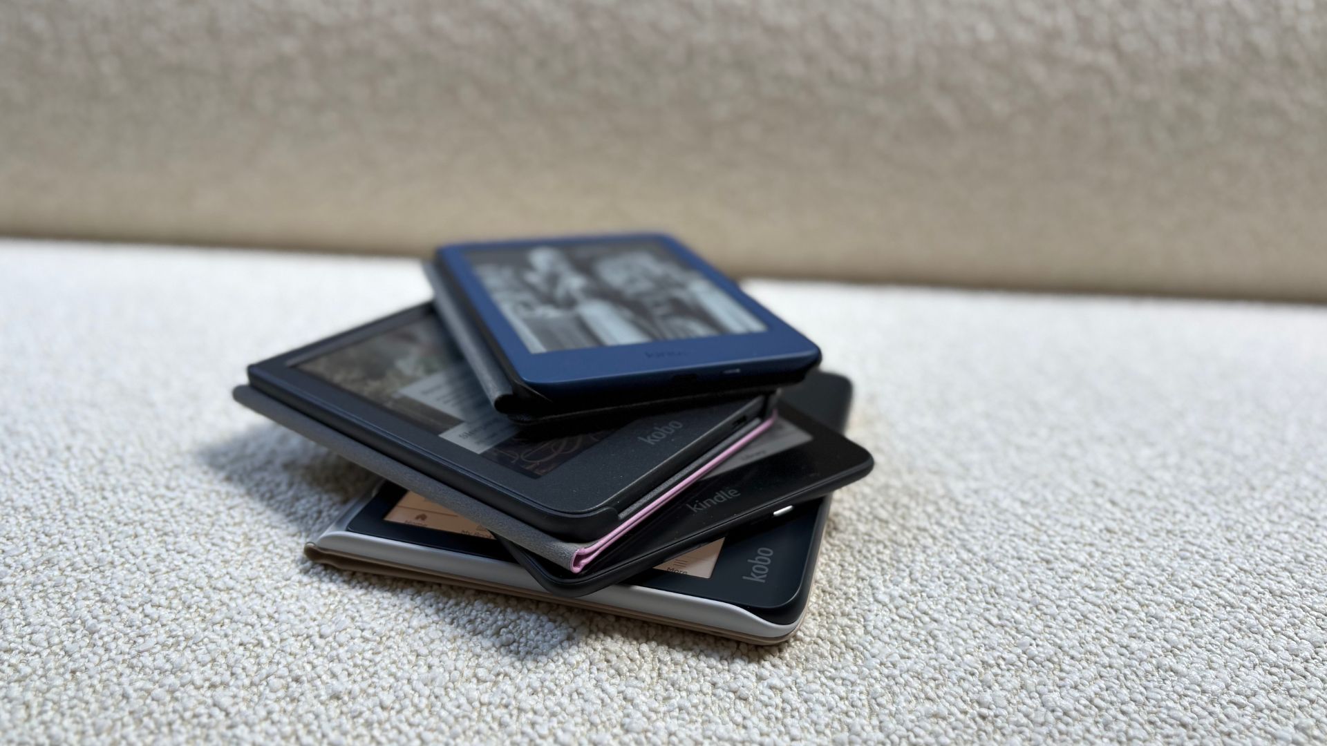 Kindles and Kobos stacked on top of each other