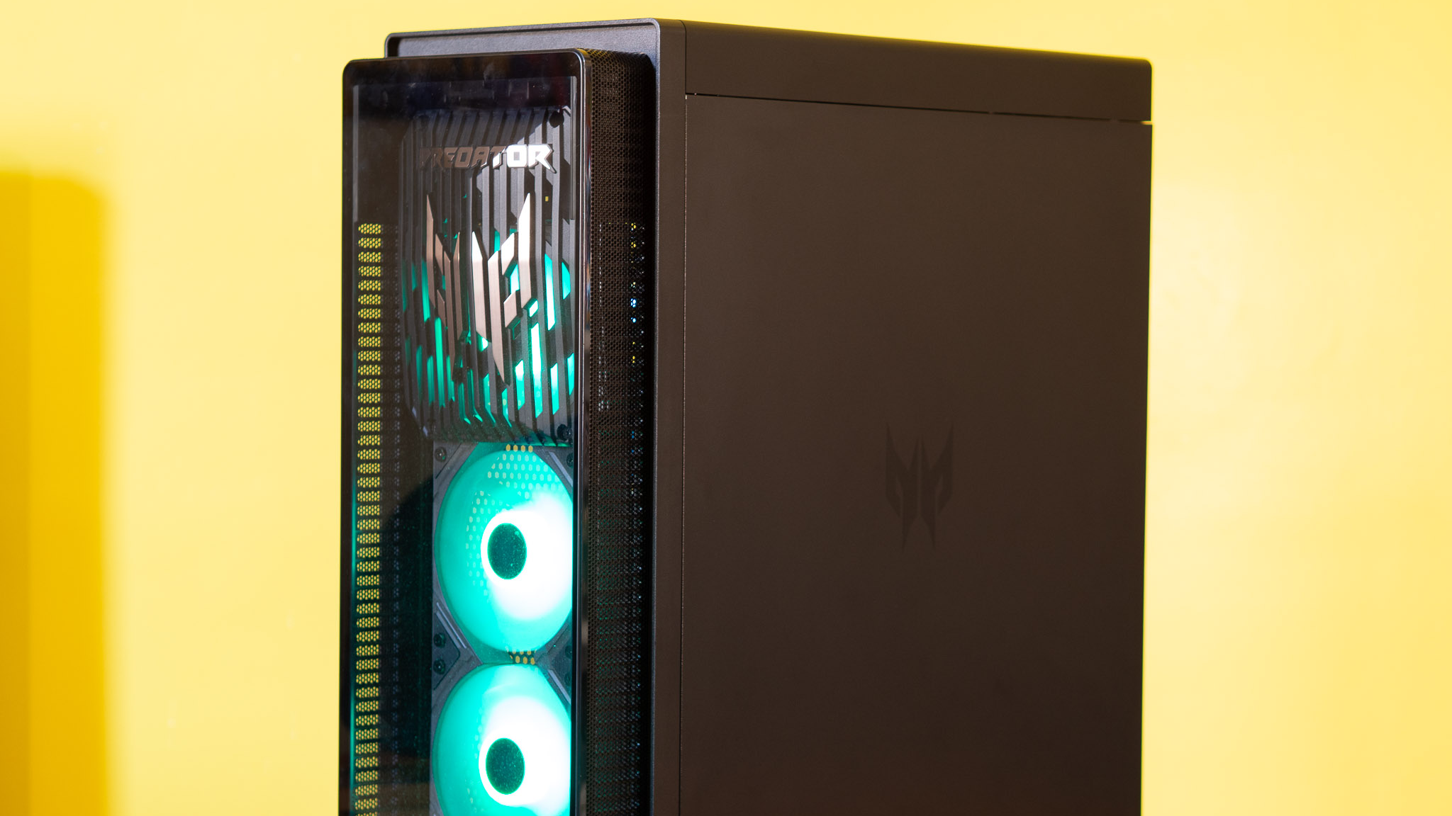 Acer Predator Orion 7000 gaming desktop PC on a wooden desk and yellow background