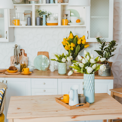 A kitchen in spring featuring a range of fresh, bright flowers