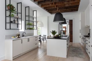 A modern kitchen with white countertops and matt black fixtures