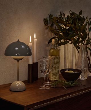 Sideboard with candle and portable table lamp
