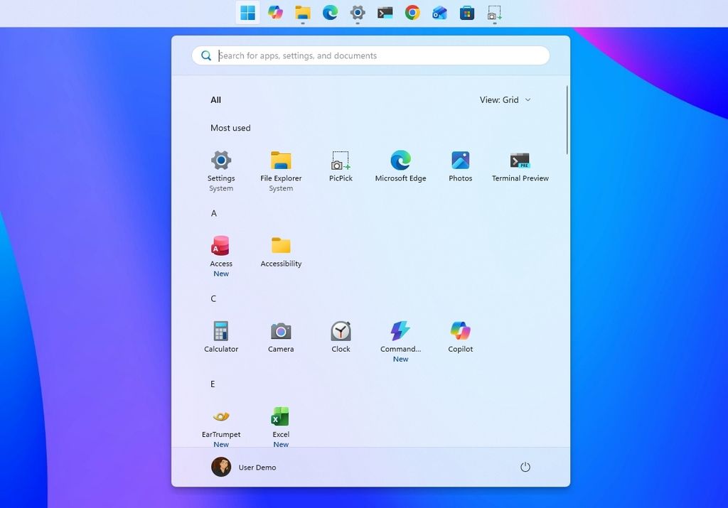 Windows 11 desktop with the Taskbar positioned at the top with the Start menu opened.