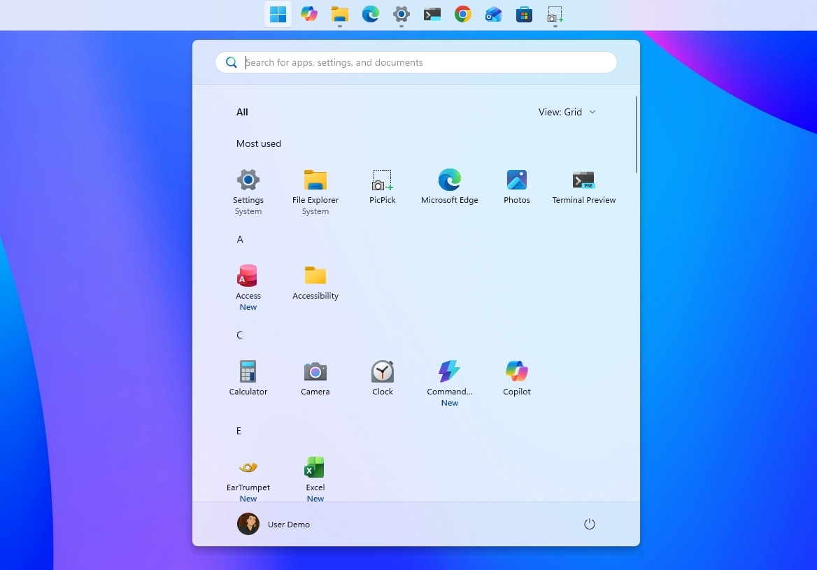Windows 11 desktop with the Taskbar positioned at the top with the Start menu opened.