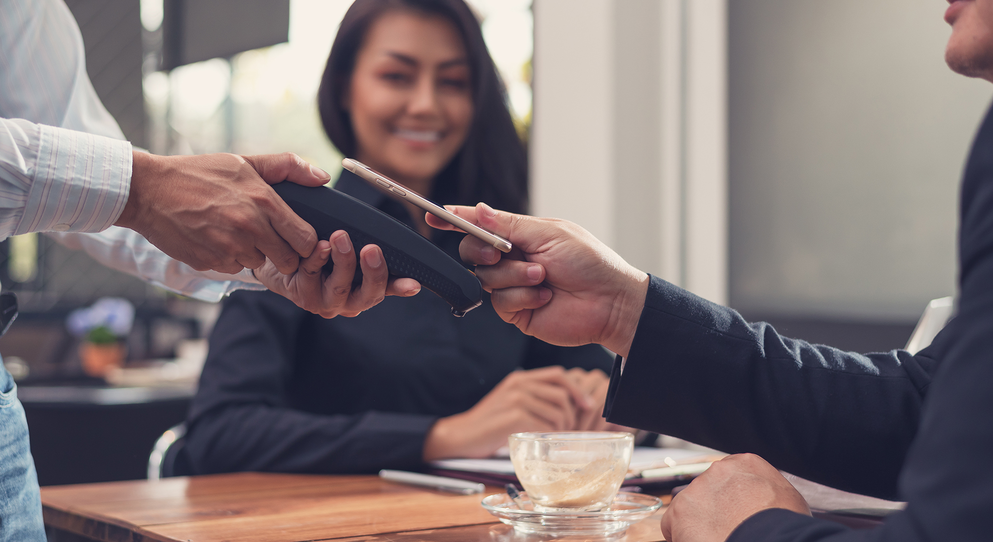 couple paying for a restaurant bill with a pos terminal