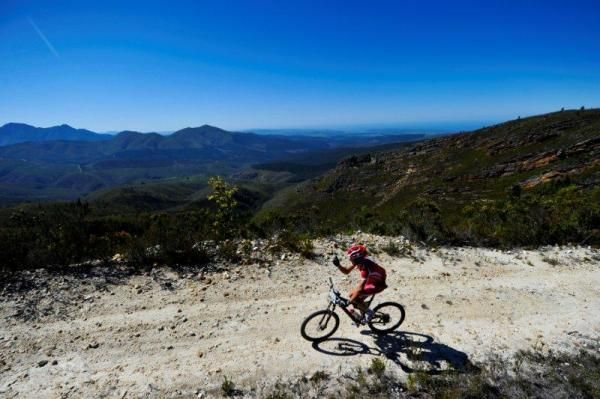 Christoph Sauser takes a second to snap a photo going over the treacherous Kammanassie Climb.