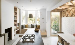 open plan kitchen diner with bay window seat and striking timber lattice work on wall and ceiling