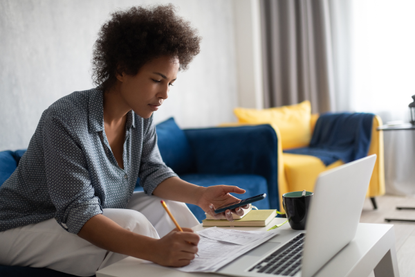 Woman researching why gas prices are rising and what happens if your energy supplier goes bust