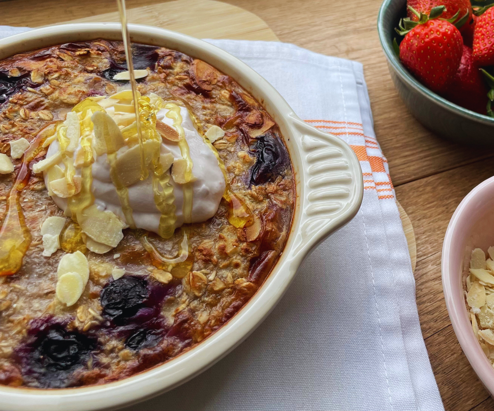 Drizzling honey over air fryer blueberry baked oats