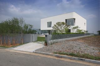 defined by a white boxy composition with curved corners this is Korea's Rounded House