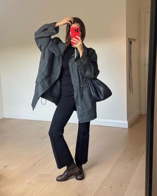  @smythsisters taking a mirror selfie in an easy winter outfit with loafers