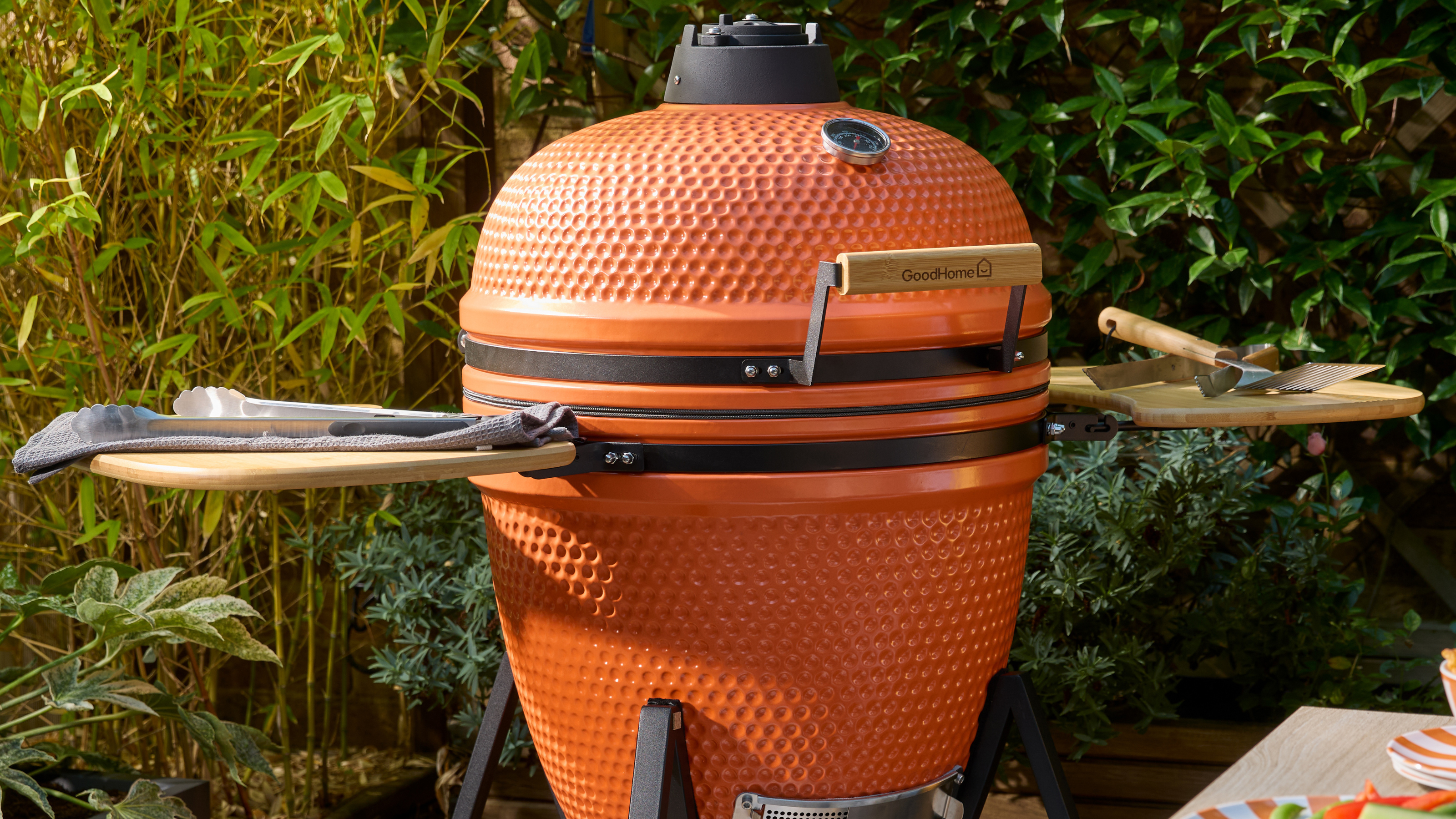 Close up of B&amp;Q's big orange egg. Behind is a wall with ivy and bamboo.