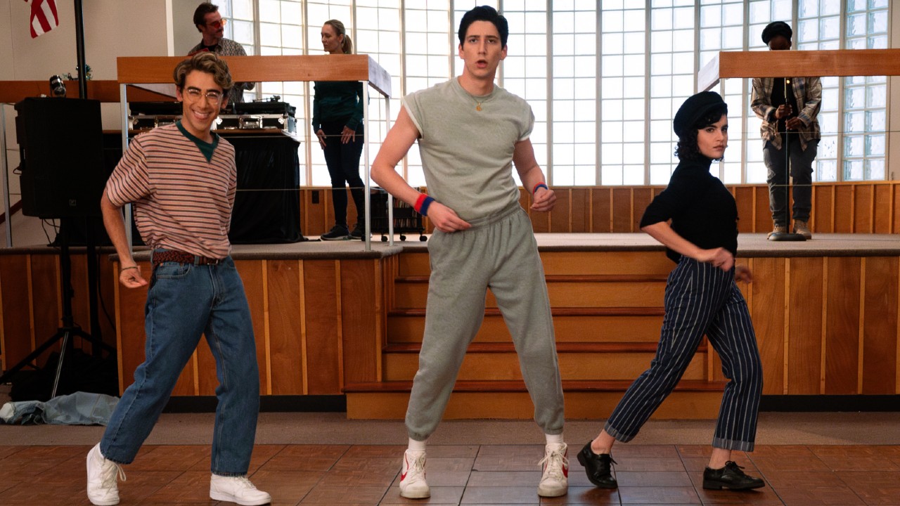 L-R: Nick Pugliese as Charley, Milo Manheim as Wally Clark and Sarah Yarkin as Rhonda all dancing by moving their hands by their hips.