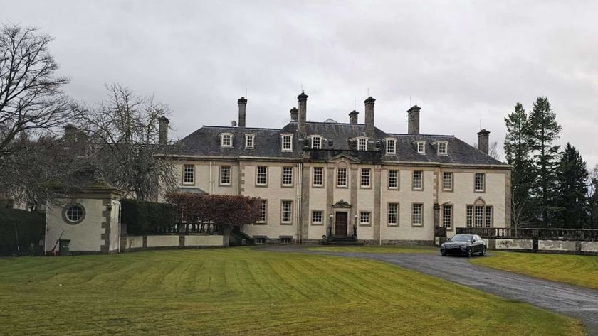 A listed Scottish mansion in the Highlands with a large front garden and driveway