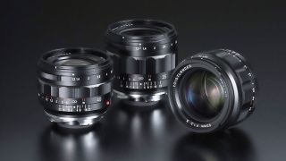 Three black camera lenses are displayed on a dark surface, showcasing their distinct designs and focusing rings, lenses displayed are NOKTON 50mm F1.2 Aspherical II, NOKTON 40mm F1.2 Aspherical II, and NOKTON 35mm F1.2 Aspherical IV