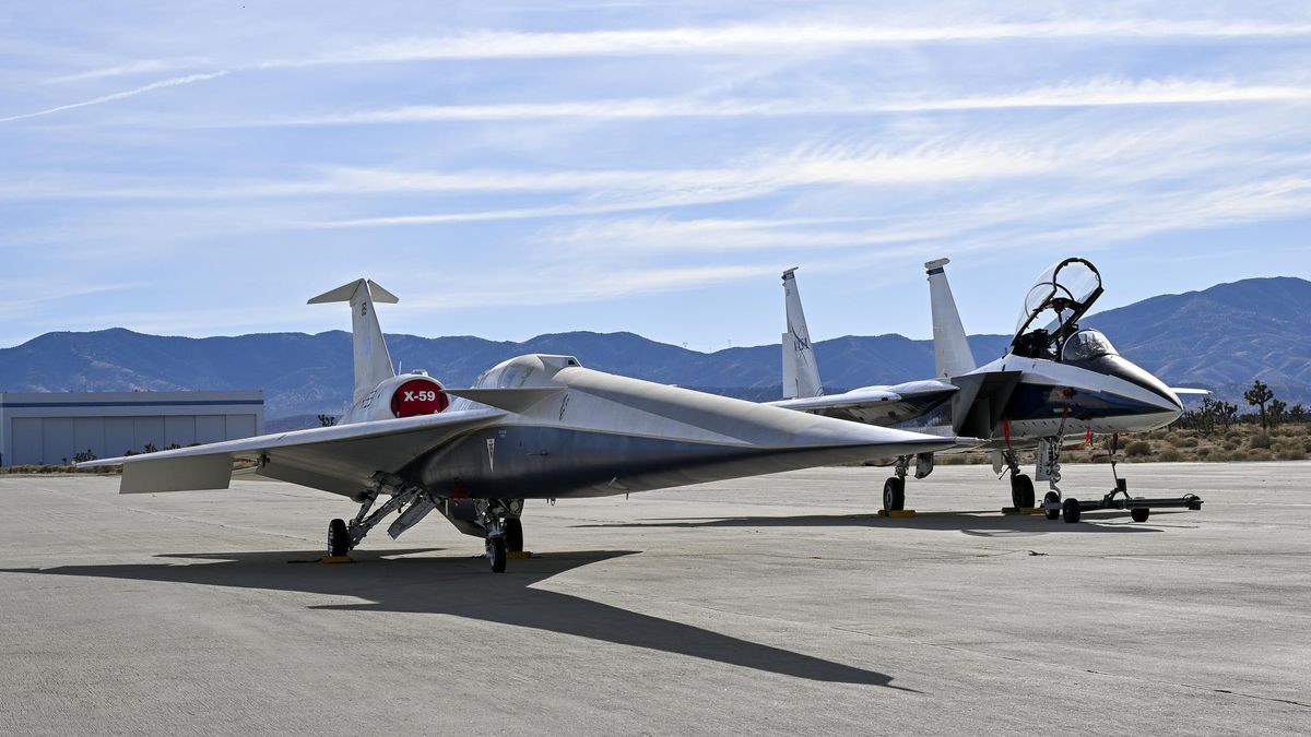 two sleek, small jets sit on a concrete tarmac in the desert