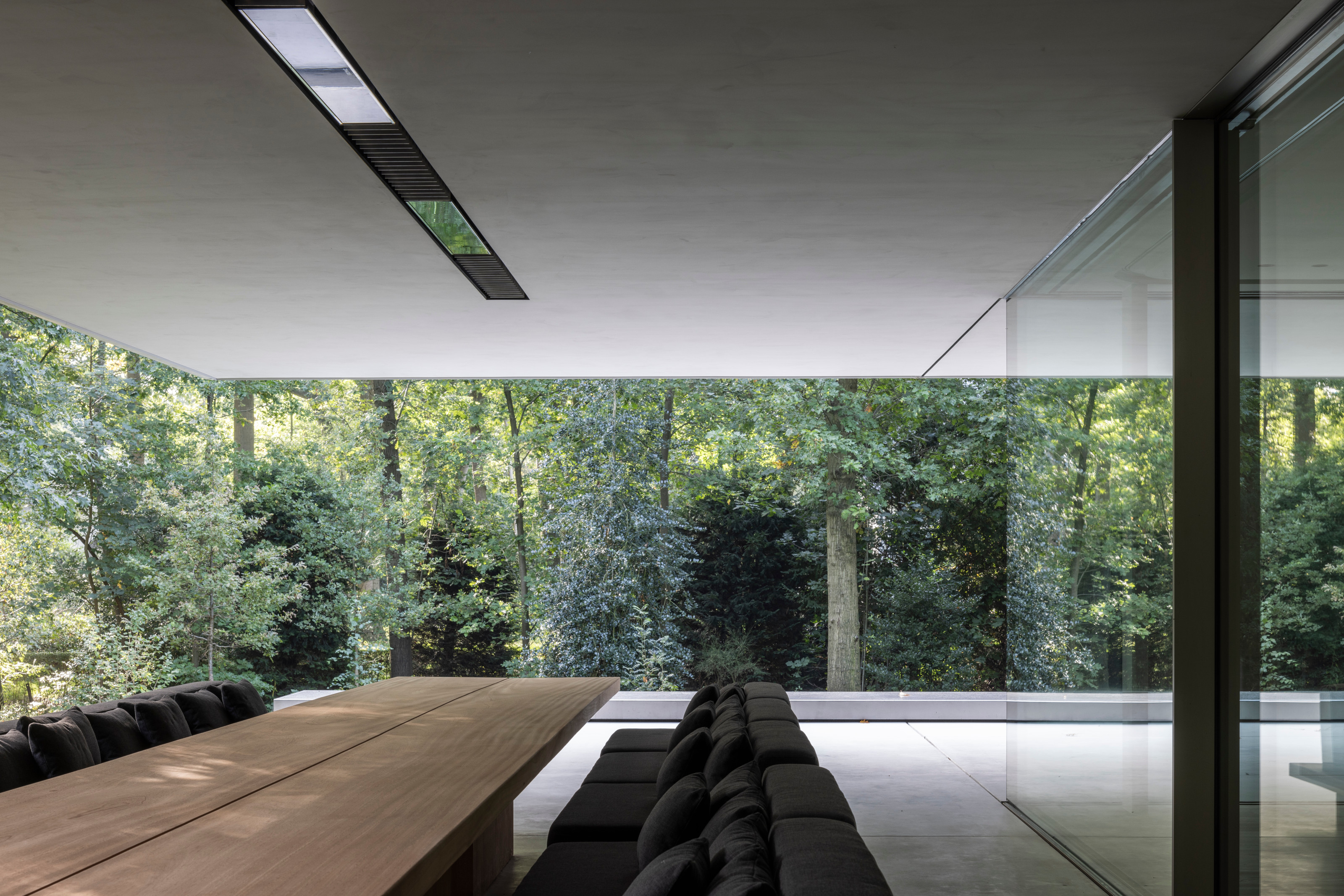 The main living space is located on the ground floor, with an external dining area under the extended roof