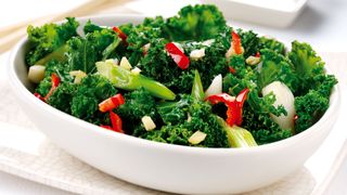 Bowl of cooked kale and ginger to show what not to cook in an air fryer