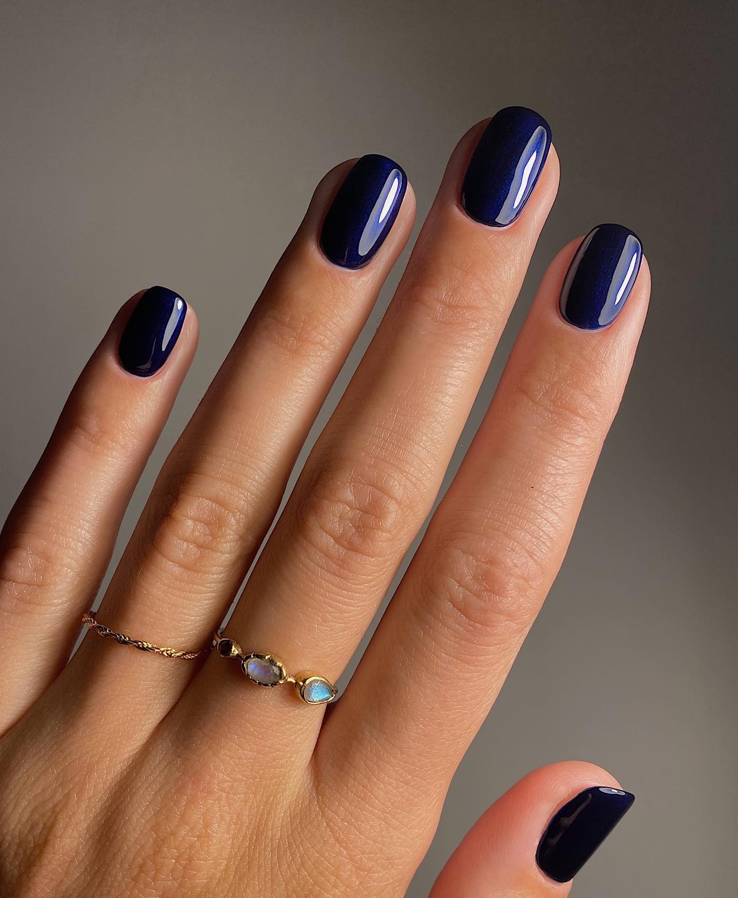 A dark blue glossy manicure