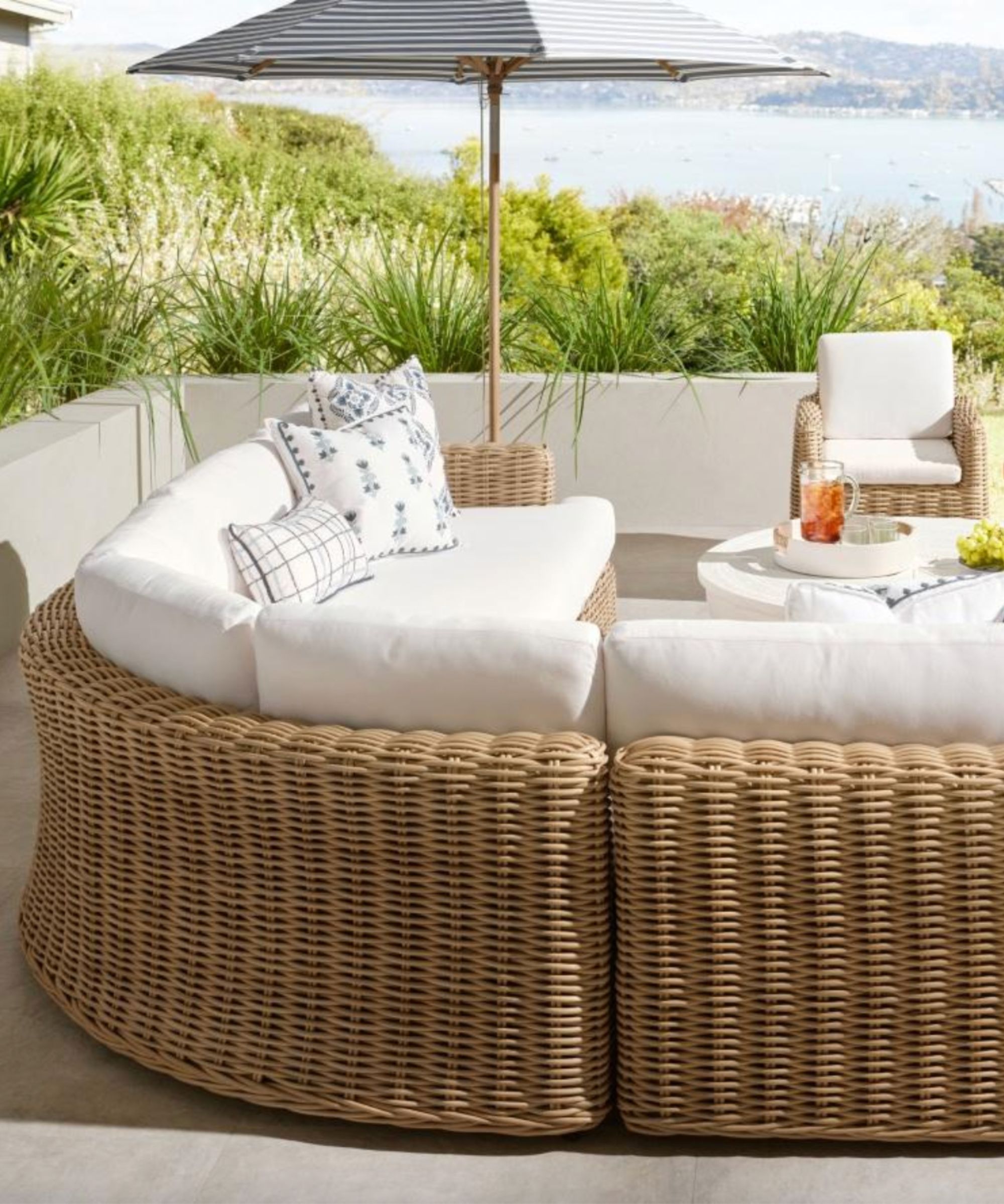 Outdoor living room with woven seating and soft planting