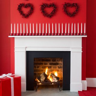 Christmas candle ideas with red fireplace wall and candle display