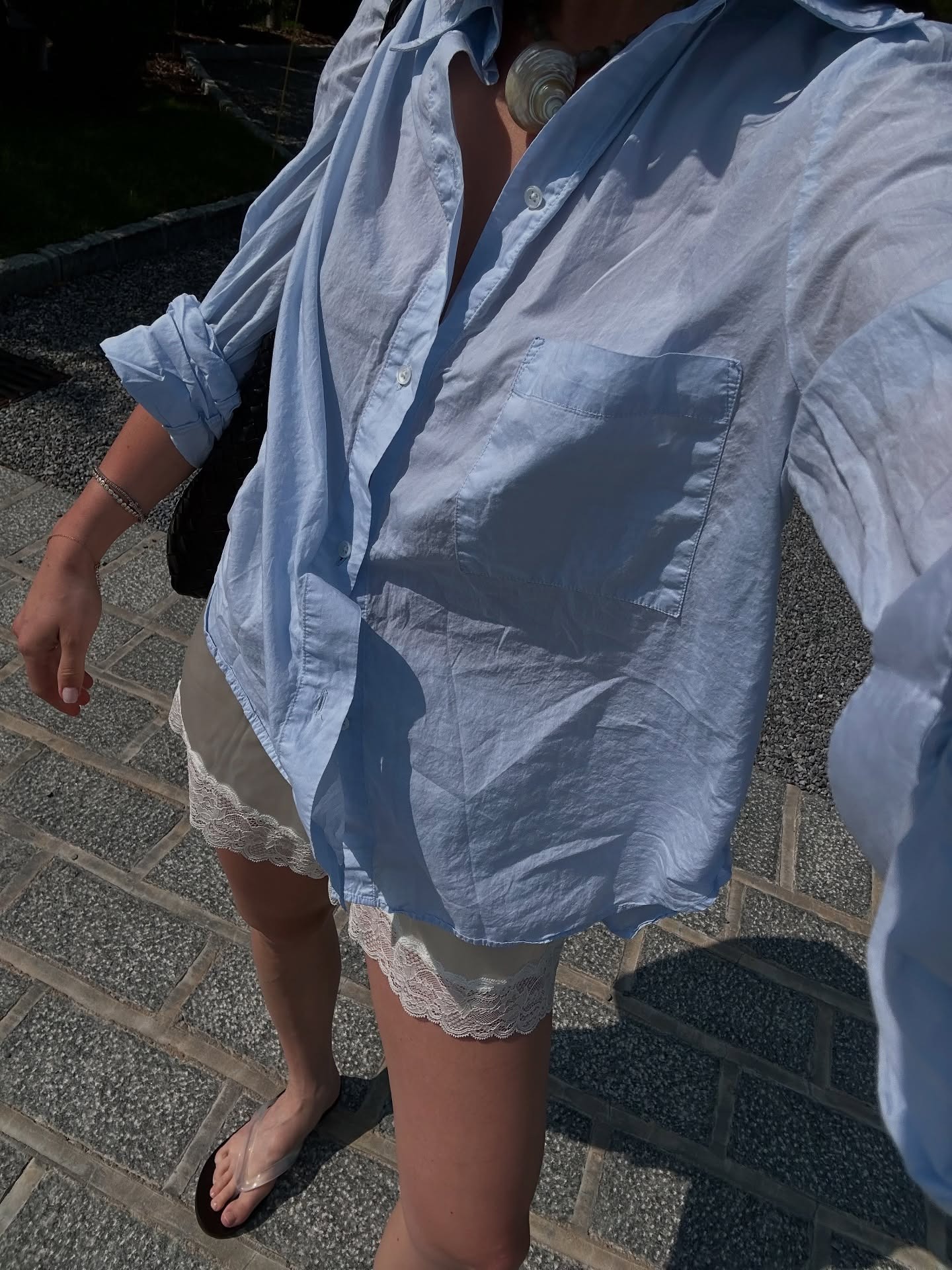 Woman in blue button-down and lace-trimmed shorts