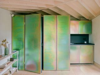 iridescent steel cupboard doors inside The Drawing Shed by ByOthers Architects