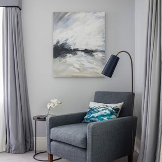 Grey room with grey armchair, curtains and pelmet