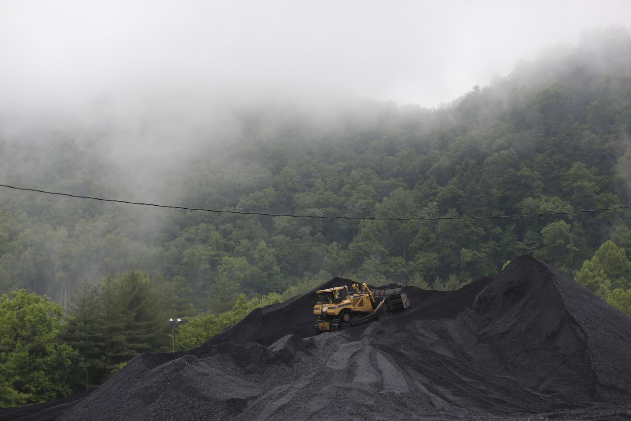 A bulldozer parked on top of a coal mound in Kentucky