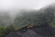 A bulldozer parked on top of a coal mound in Kentucky
