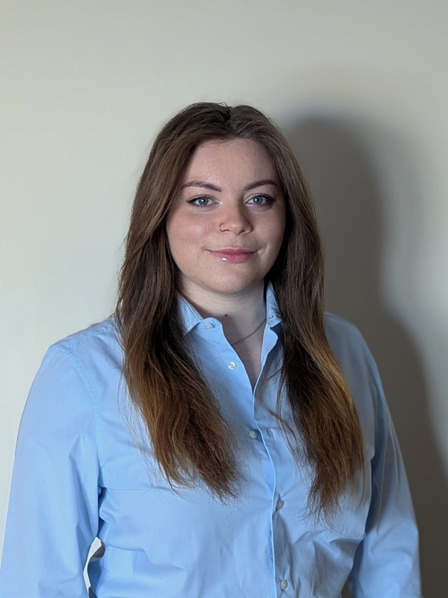 Young woman below pension age standing in a shirt