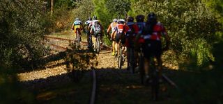 Riders roll along on railroad tracks during stage 2 at the Andalucia Bike Race.