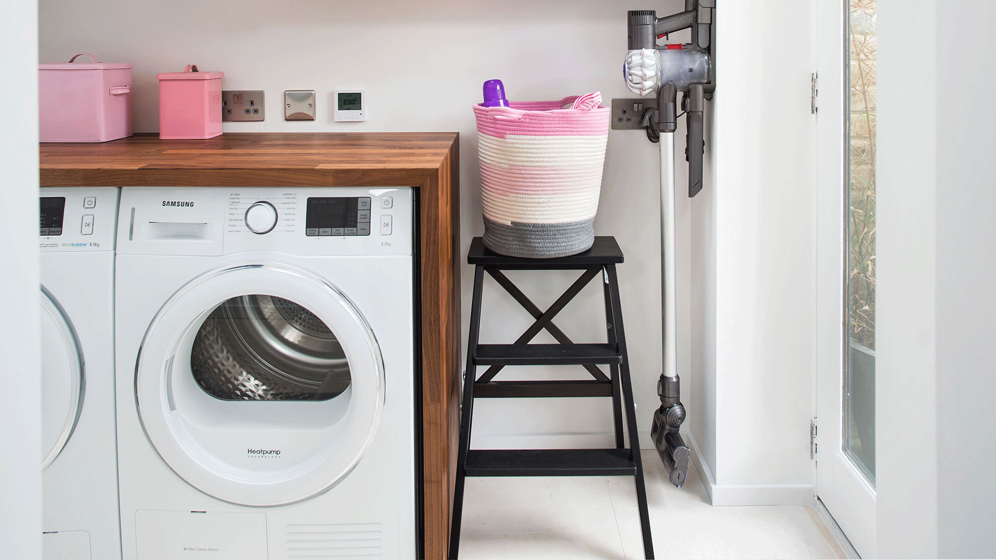 Utility room with flower stickers on washing machine