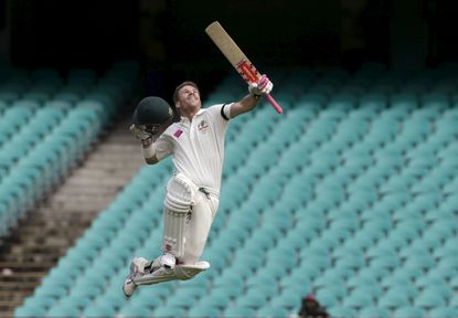 Australian batsman David Warner celebrates scoring a century against the West Indies on the final day of their third cricket test in Sydney.