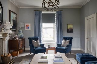 blue living room with blue armchairs blue curtains and blue window blind
