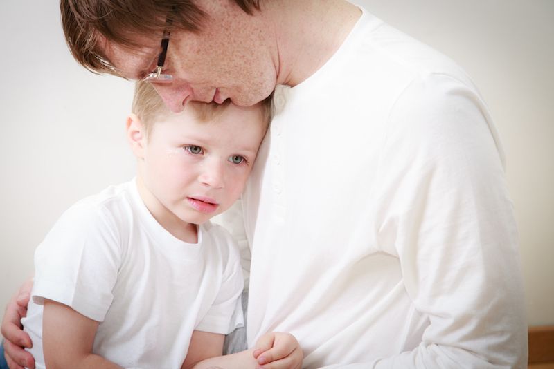 father comforting scared kid