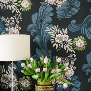 wallpaper on wall with table lamp and flower vase