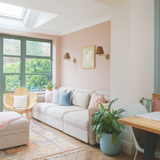 Boho cream living room with pale furniture and herringbone floor.