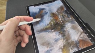 Darkboard iPad drawing stand; a hand holds an Apple Pencil over an iPad drawing stand