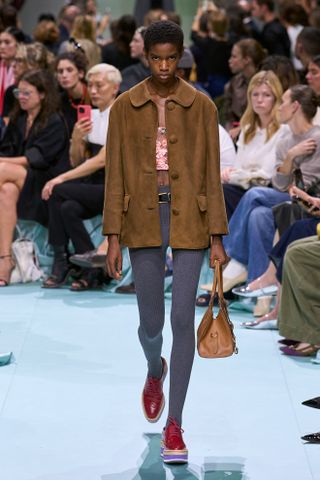 a Prada model walks the spring/summer 2025 runway in skinny leggings