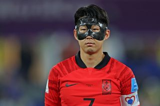 South Korea captain Son Heung-min, wearing a protective mask, looks on ahead of the 2022 World Cup quarter-final match against Brazil in Qatar.