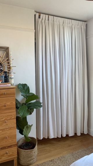 Bedroom with DIY closet with curtain as door