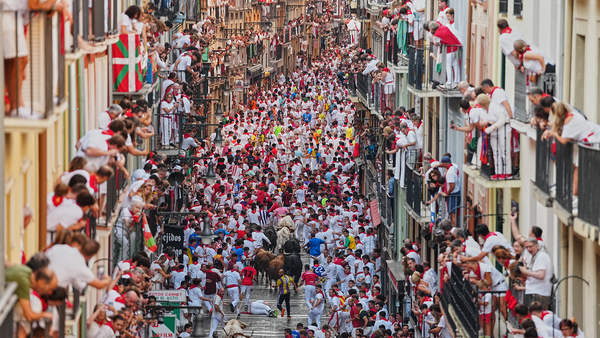 Crowds of people surge through the streets of Pamplona during the running of the bulls at the San Ferm&amp;iacute;n festival in Pamplona, Spain