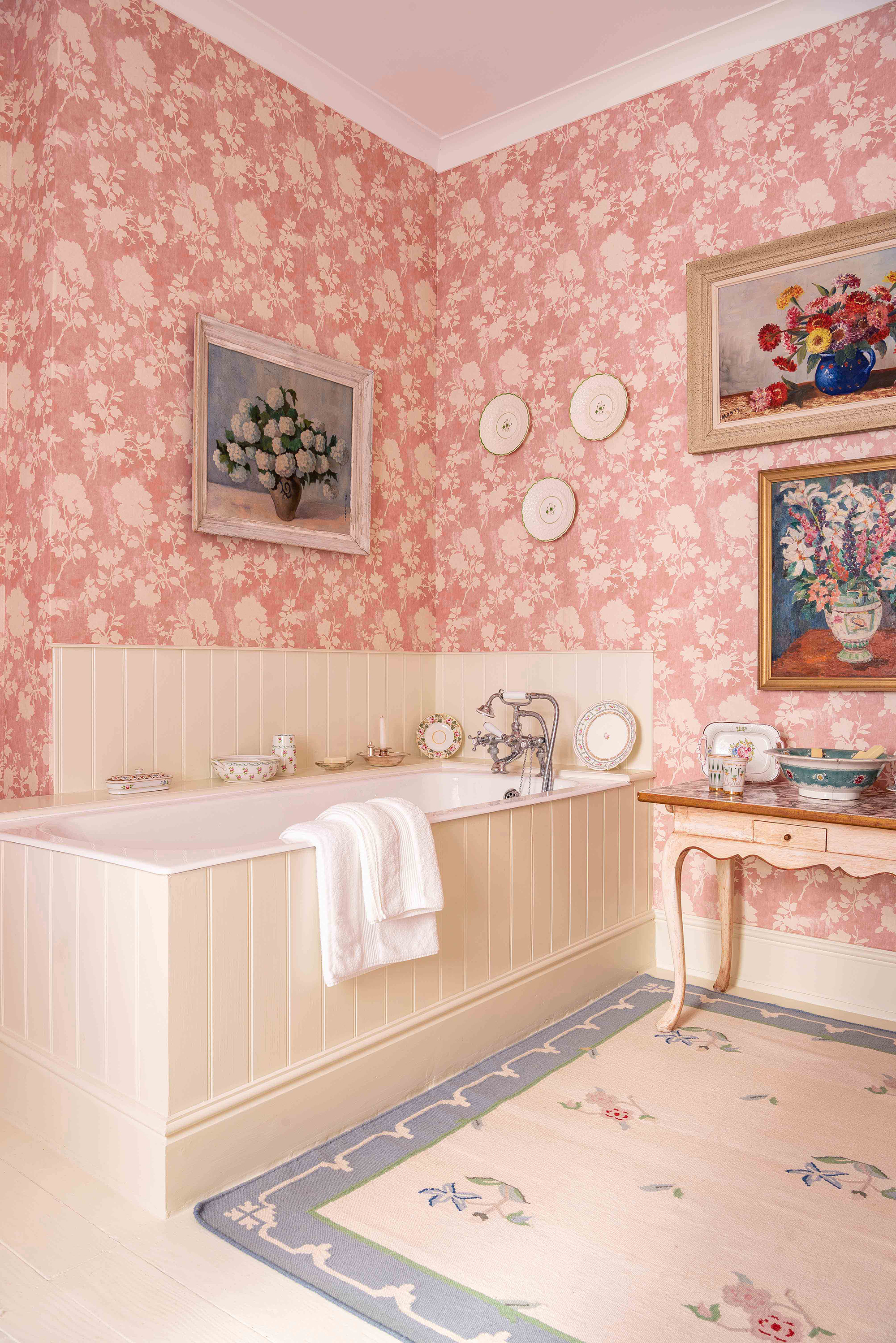 A vintage-style bathroom with Penny Morrison Flowerberry pink wallpaper